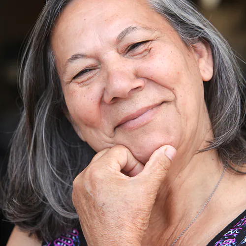 Older woman smiling thoughtfully during individual therapy